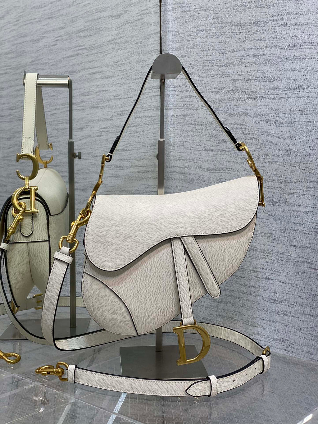6. Dior Saddle Bag M0455 worn crossbody on a casual white outfit