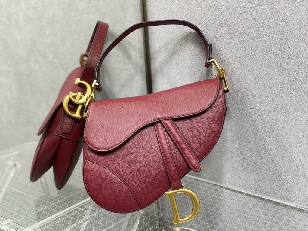 1. Dior M0455 Saddle Bag oblique angle with strap hanging