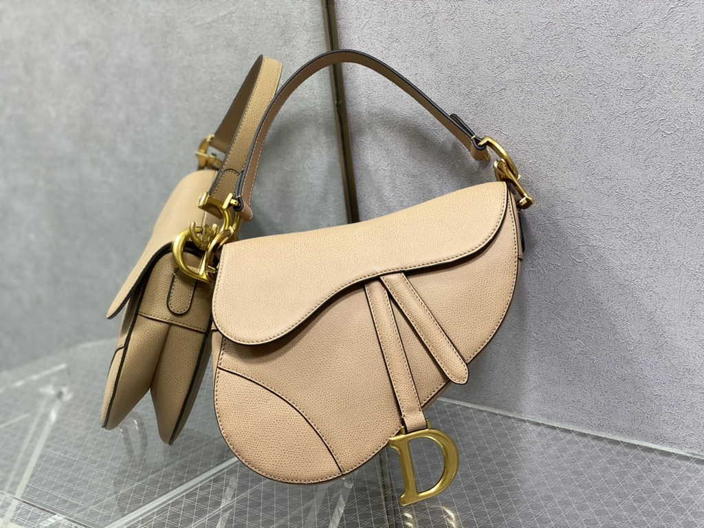 6. Dior M0455 Saddle Bag carried by hand in an urban street style look