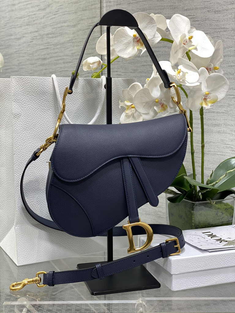 31. Dior Saddle Bag M0455 flat lay on a neutral table top