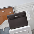 Herm¨¨s Kelly D¨¦p¨ºche 36 open with a leather notebook and pen ¨C practical luxury daily briefcase