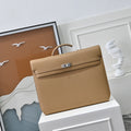 Top handles and removable canvas strap of Herm¨¨s Kelly D¨¦p¨ºche 36 ¨C worn as a top handle or crossbody